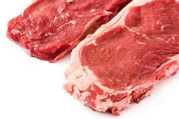 Raw beef steak ready to be cooked isolated on white background