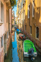 Scenic view of Venice narrow canal with old architecture and colorful boats