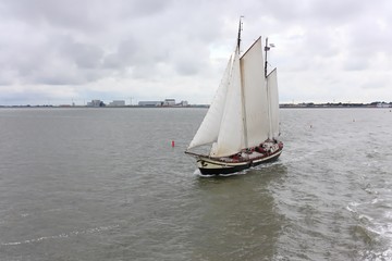Sailing ship on the Wadden Sea, leaving the port of Harlingen in the Netherlands