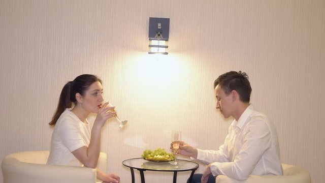 Romantic rendezvous of a man and a woman with fruits and champagne.