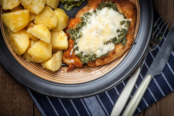 Fried chicken fillet with spinach and cheese.