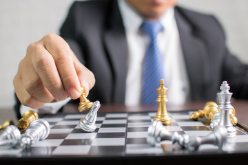 success, management and business leadership concept,hand of  businessman moving king chess to win by using strategy and planning