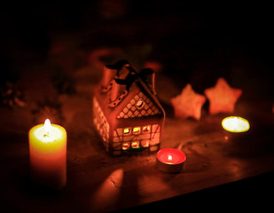 gingerbread house candle on blurred background of the table.