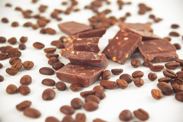 close up.pieces of chocolate and coffee beans isolated on white.photo with copy space