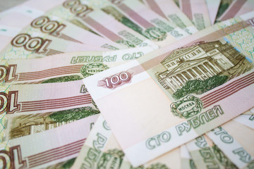 business, finance, saving, banking concept - close up bundle of money Russian Banknotes one hundred rubles