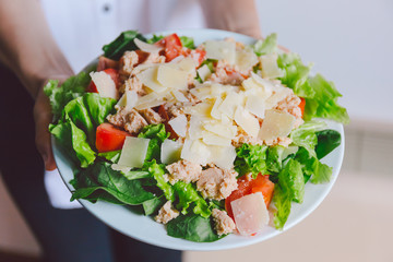 Girl holding healthy salad ready to eat