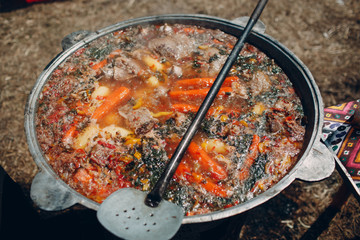 Shurpa soup in a large cauldron outdoor