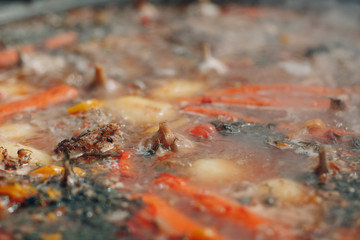 Shurpa soup in a large cauldron outdoor