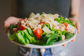 Girl holding healthy salad ready to eat