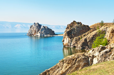 Fototapeta na wymiar Baikal Lake on a summer afternoon. Beautiful landscape of the island of Olkhon with coastal rocks near the village of Khuzhir. Natural attractions - Shamanka Rock and Tataiskiy Cape