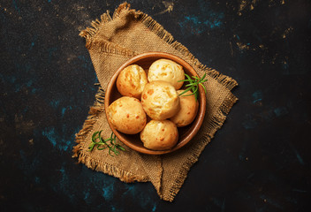Tasty buns with rosemary, rustic style, black background, top view