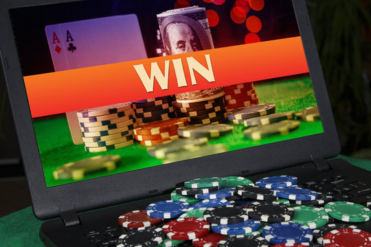 A lot of poker chips on the laptop with the inscription "win"