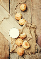 Milk and homemade buns, rustic style, vintage wooden background, top view