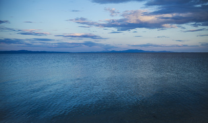 Seascape on evening sky. Sea with blue water after sunset. Summer vacation in tropic. Discovery...