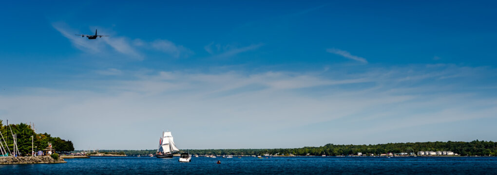 Tall Ship In Full Sail On The St. Lawrence River With A Military Transport Airplane Flyover