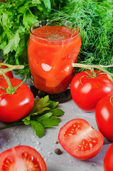 Tomato Juice and Fresh Tomatoes isolated on a stone Background
