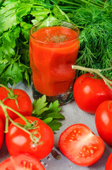 Tomato Juice and Fresh Tomatoes isolated on a stone Background