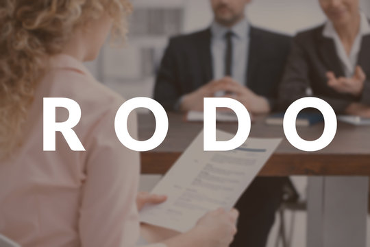 Woman holding her resume during a job interview. Concept of protecting personal data in accordance with RODO