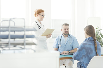 Friendly gynecologist talking with patient