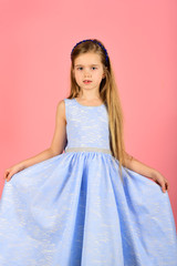 funny little girl with long hair and make-up. Kid's fashion