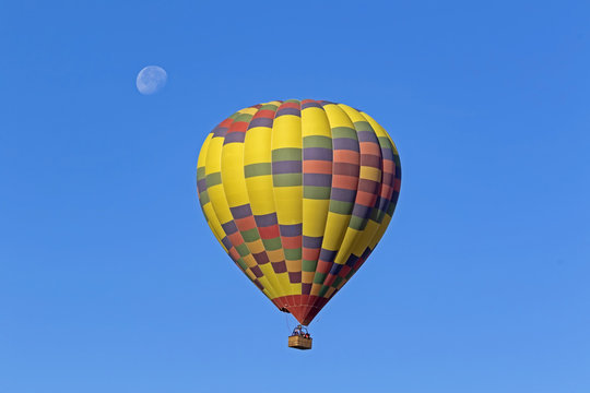 Hot air balloon ride in the sky with the morning moon