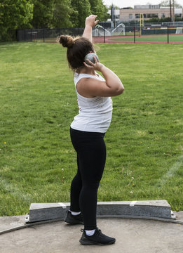 Female shot puter setting up to throw