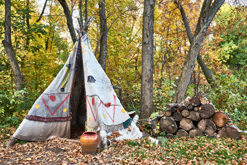 Tepee in the autumn forest. Indian tent exhibition. © Suslov Denis