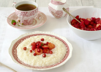 A useful breakfast of rice porridge with strawberry sauce served with tea.
