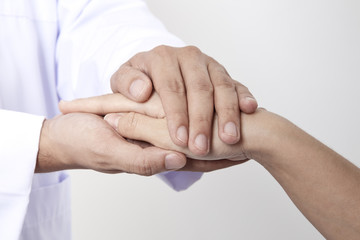 Hand of doctor reassuring her female patient