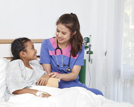 Doctor caring with love little girl in hospital