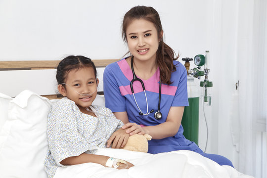 Doctor caring with love little girl in hospital