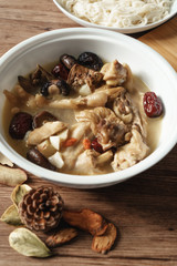 A nutritious chicken soup with a woody background