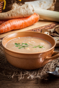 Mushroom soup on a wooden table.