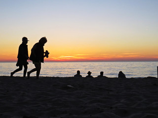 People Observing Romantic Sunset at Sand Beach Seaside