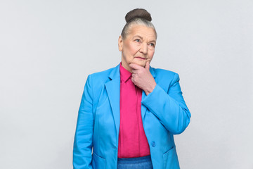 Puzzled woman thinking and touching chin