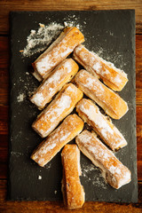 Strudel Apple and sugar powder. Biscuit from the puffed Test on the Gray Background. Dessert with...