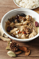 A nutritious chicken soup with a woody background