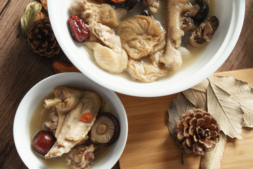 A nutritious chicken soup with a woody background