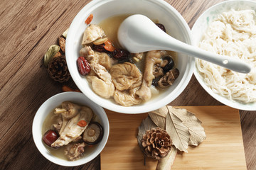 A nutritious chicken soup with a woody background