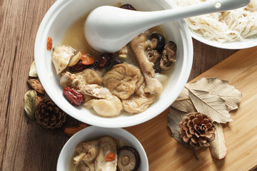 A nutritious chicken soup with a woody background