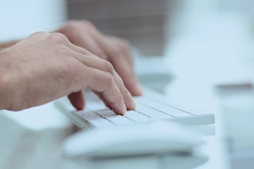 close-up of hand typing text on computer keyboard.