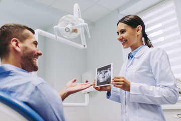 doctor showing x-ray to the patient