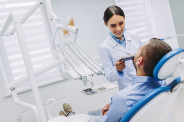 dentist and patient choosing tooth implants