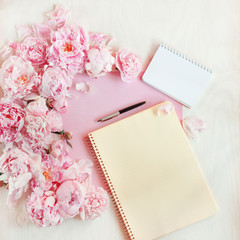 flat lay concept with writing pad, pen, coffee and beautiful peonies, can be used as background 