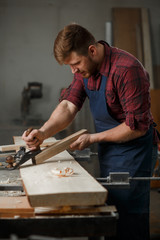 Portrait Male Master carpenter apron in his workshop. Small business