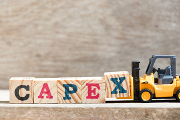 Toy forklift hold letter block X in word capex (abbreviation of capital expenditure) on wood background - obrazy, fototapety, plakaty