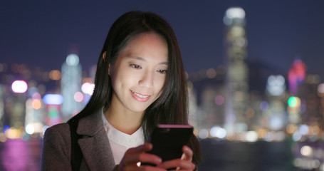 Business woman use of smart phone at night