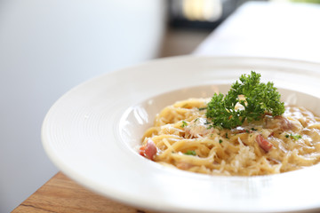 Spaghetti white sauce (Spaghetti Carbonara) with bacon and garlic , on wood table background