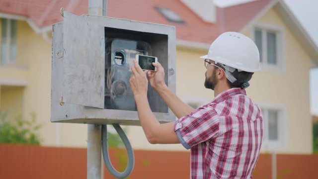 The inspector takes pictures of the meter reading