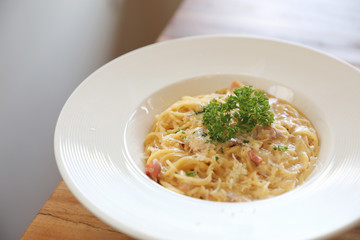 Spaghetti white sauce (Spaghetti Carbonara) with bacon and garlic , on wood table background